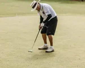 Old man playing golf